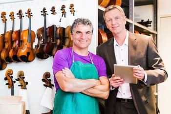 affinity insurance programs - small business owner in front of violins
