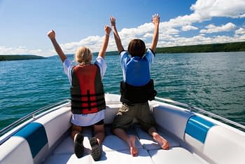Kids enjoying a ride on their boat with boat insurance