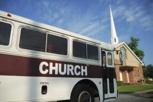 Church bus, car, van in front of church - church car insurance